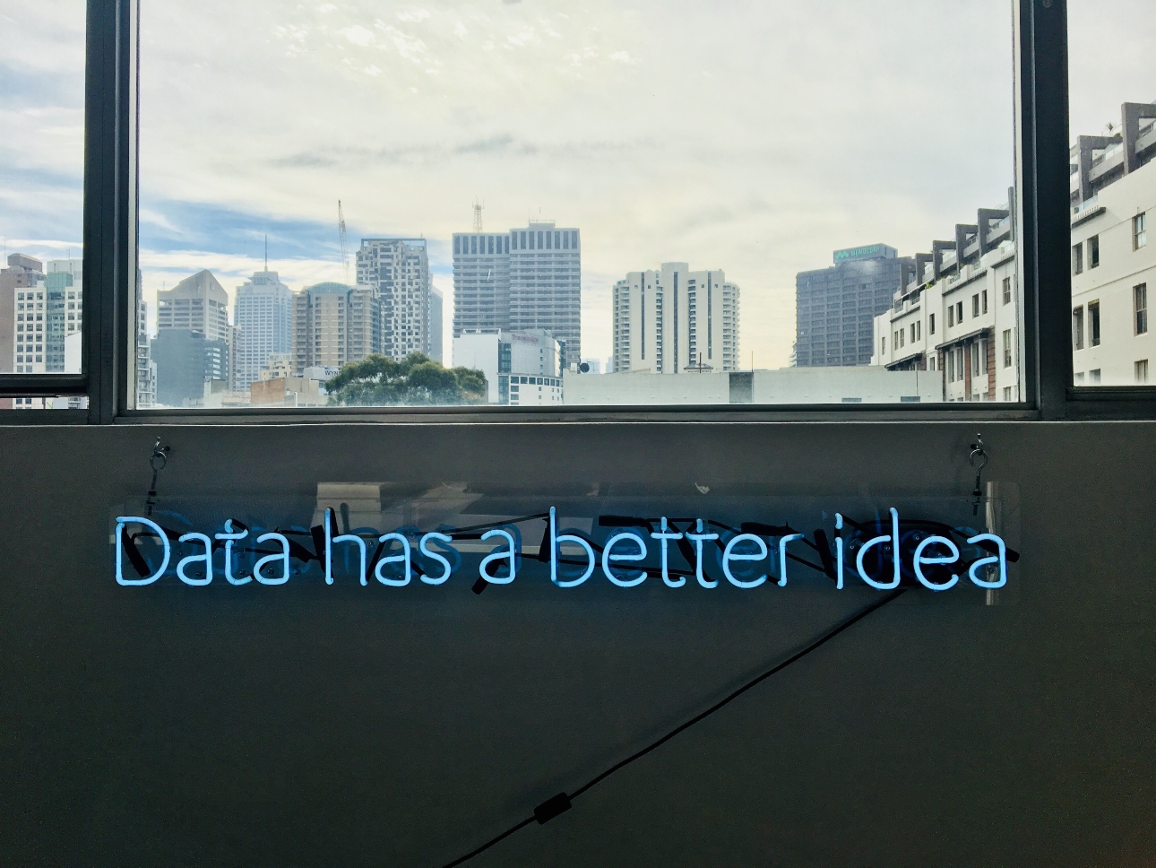 data-has-a-better-idea-sign-below-city-skyline