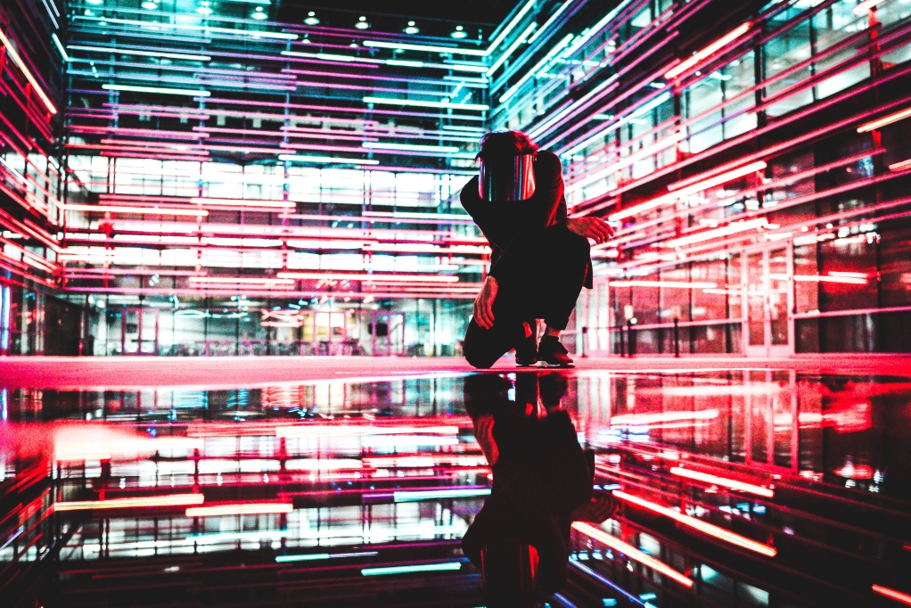 man-in-welding-mask-in-front-of-neon-lights