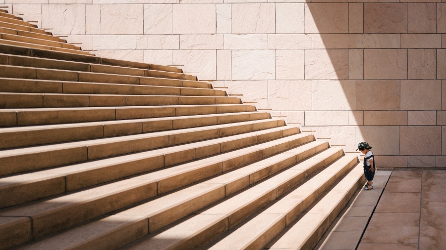 small-child-at-foot-of-large-stairs