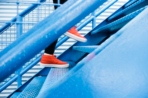 Side view of person walking up stairs