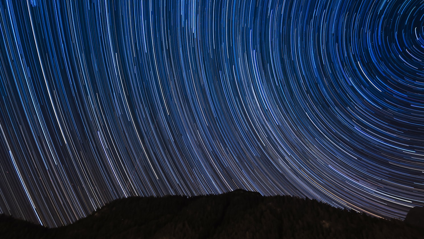 Mountain with lights in sky