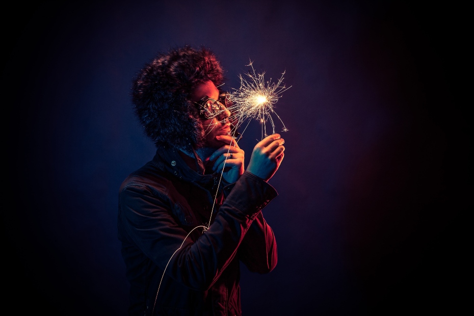 man-looking-at-sparkler.